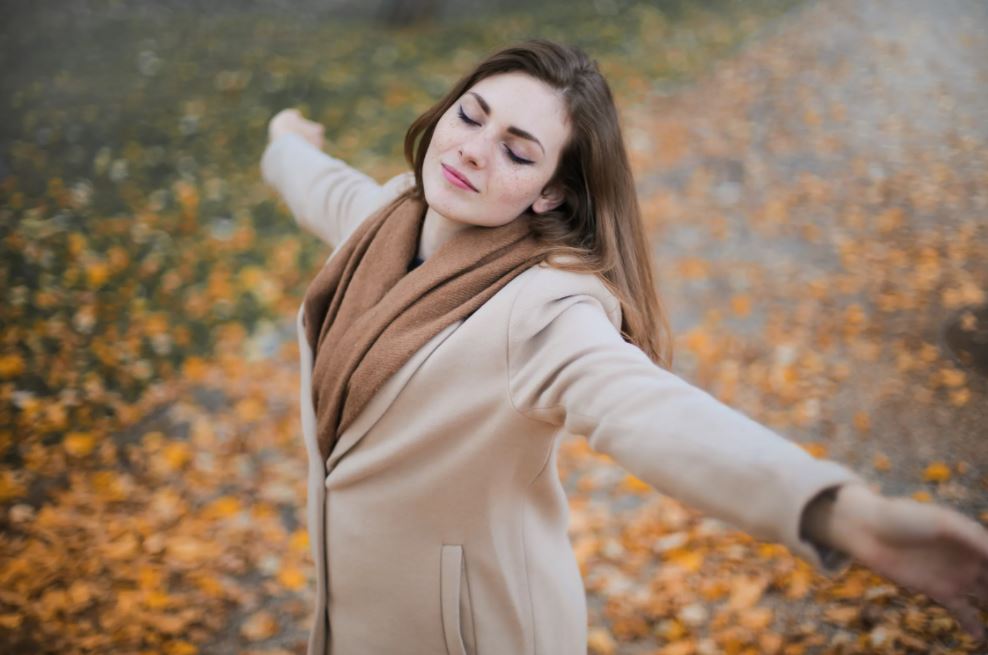 woman standing in leaves